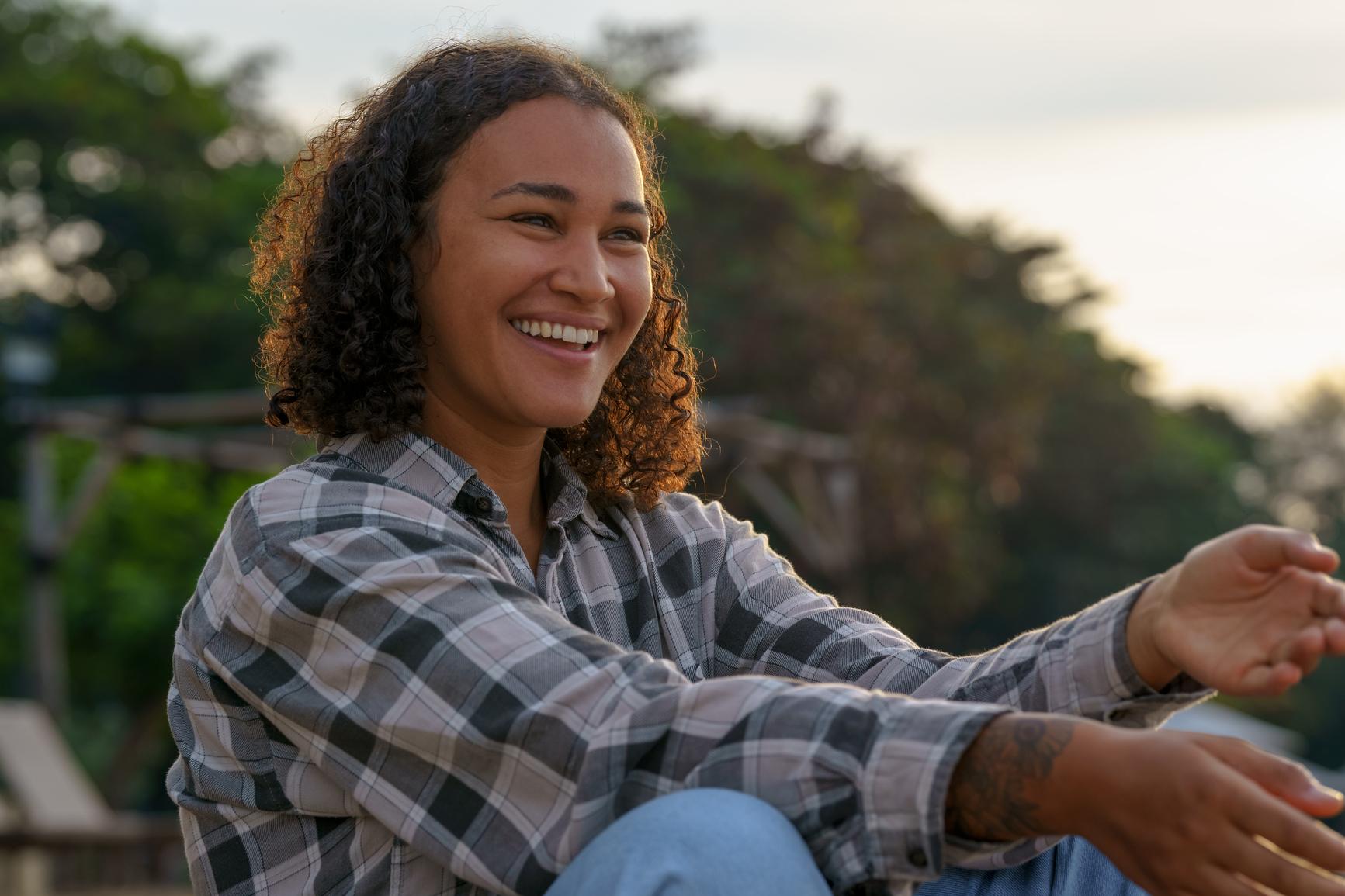 Happy woman sitting in nature