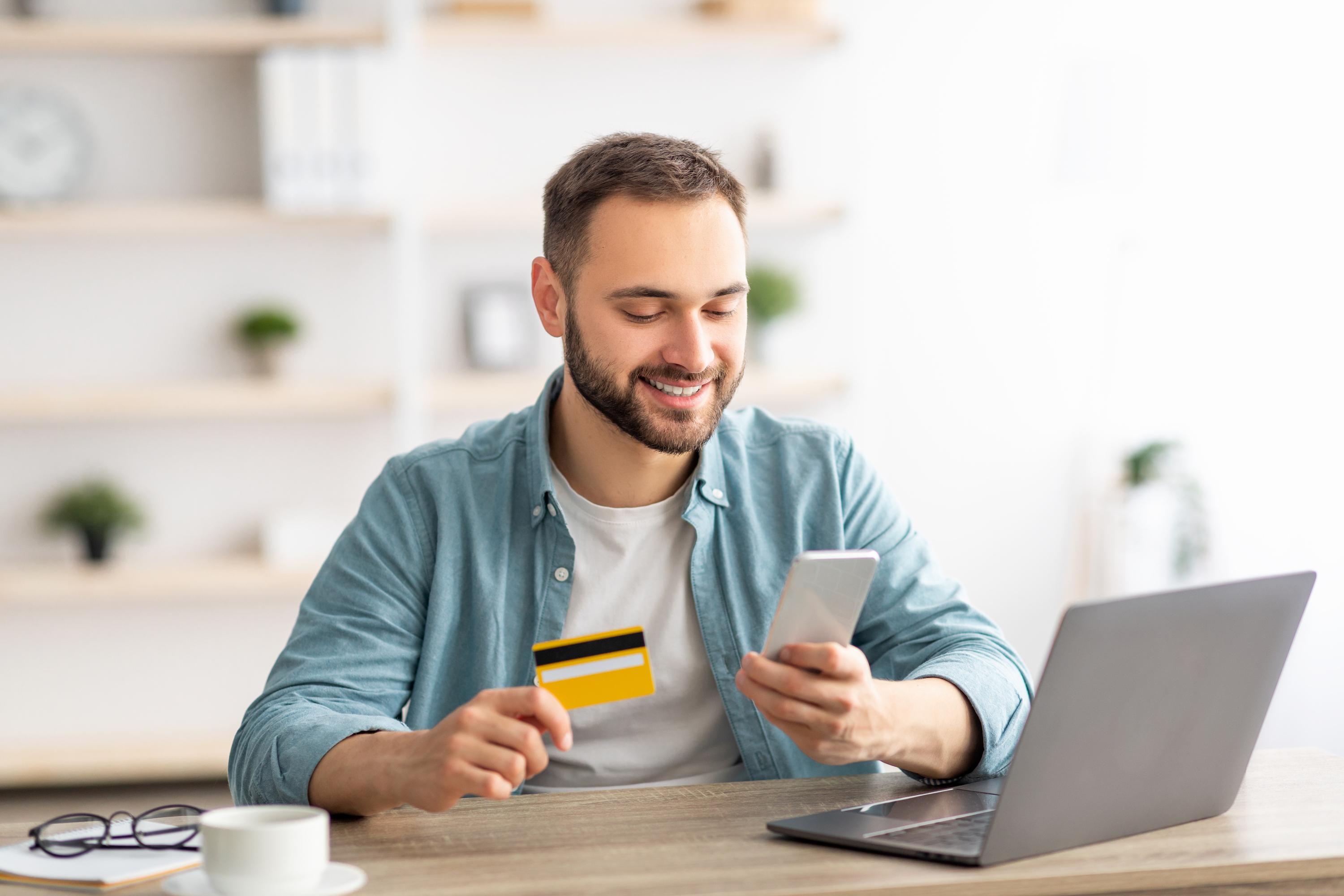 Person inputting their credit card info onto their phone